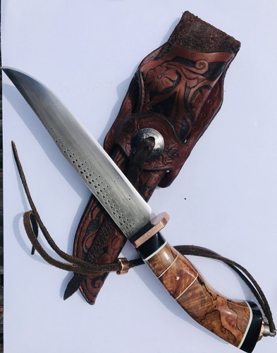 “Pig sticker” forged from an old rasp. Guard, butt cap finial and lanyard bead are coin mokume gane, with domed copper pins. Handle is spalted tamarind, maple burl, and black paper micarta, with G10 and copper spacers. Tooled leather Mexican loop sheath with Sheridan style pattern and domed coin concho.