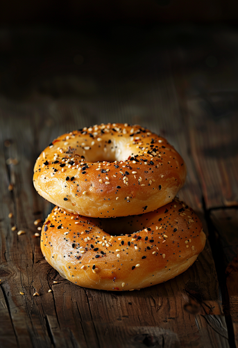 dterox two bagels with black and white pepper on top sitting a23629ed 8c10 4ded bb05 05b04317e46b 1.png