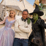 L to R: Ariana Grande (as Glinda), Director Jon M. Chu, and Cynthia Erivo (as Elphaba), on the set o