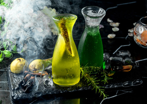 glass bottle with pear cocktail with pear slices.jpg