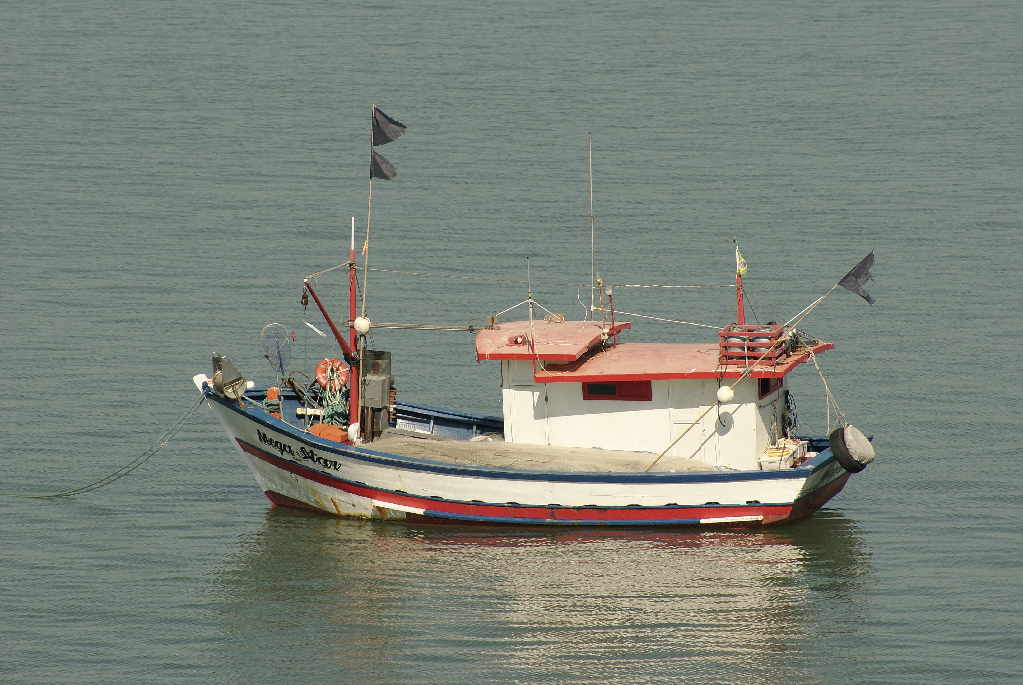 Captain steering a small fishing boat