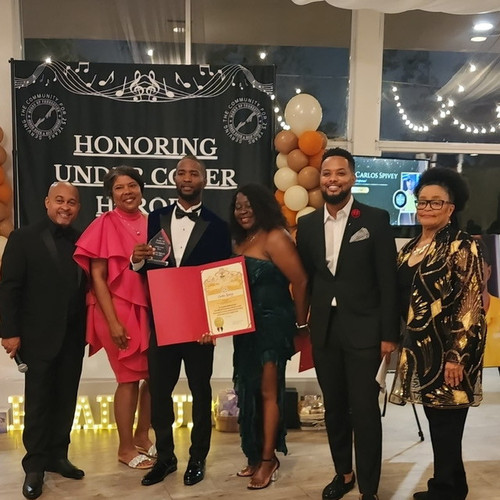 Barber cutting hair at a community event