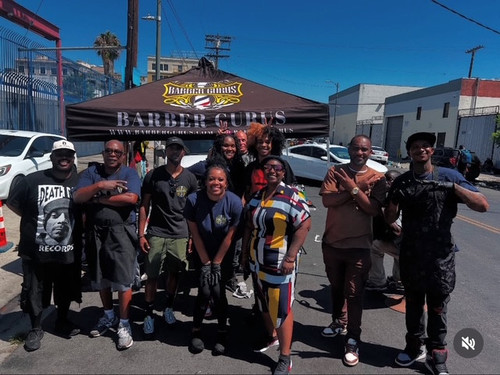 Community event group photo with Barber Gurus banner