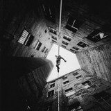 MAN ON A TIGHTROPE IN BERLIN KREUZBERG, LATE 1970s/ EARLY 1980s