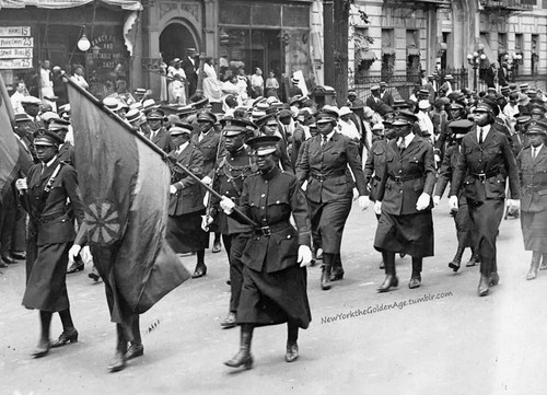 Uniformed attendees to a Marcus Garvey rally carry flags of the movement as they parade up Seventh A.jpg