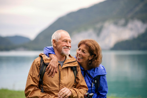 A senior pensioner couple hiking by lake in nature, resting..jpg