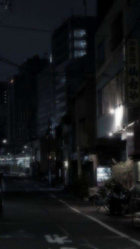 a street at night with buildings in the background.jpg