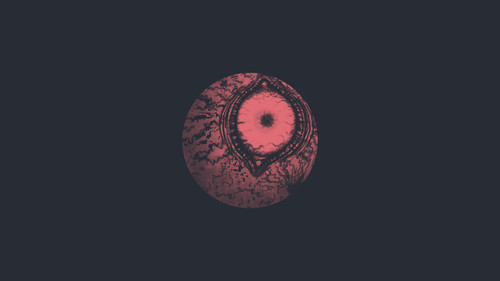 a red and black round object with a black background.jpg