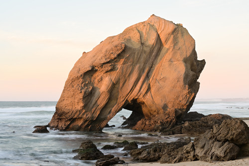 a large rock formation on a beach.jpg