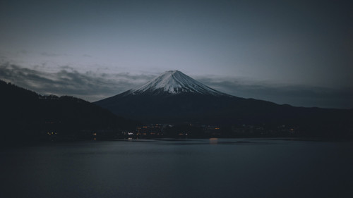 a mountain with snow on top and a body of water 01.jpg