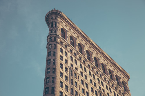 a tall building with many windows with Flatiron Building in the background.jpg