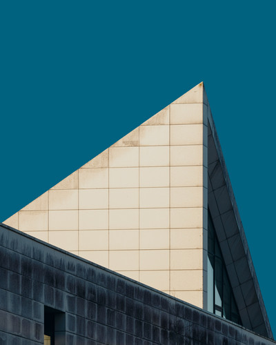 a triangular building with a blue sky.jpg