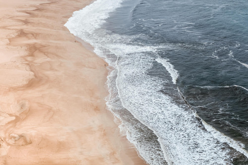 a beach with waves crashing on the shore.jpg