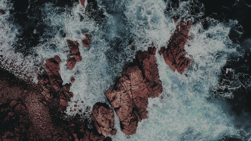 waves crashing on rocks.png