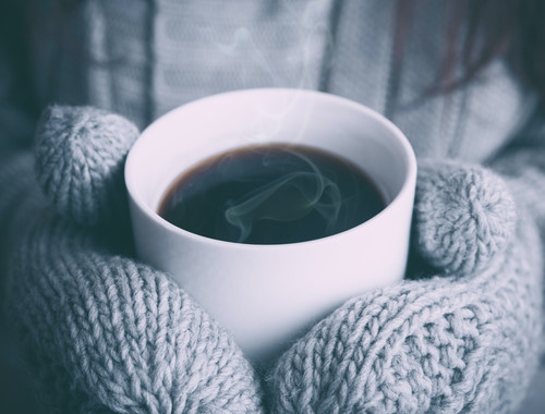 a person holding a cup of coffee.jpg