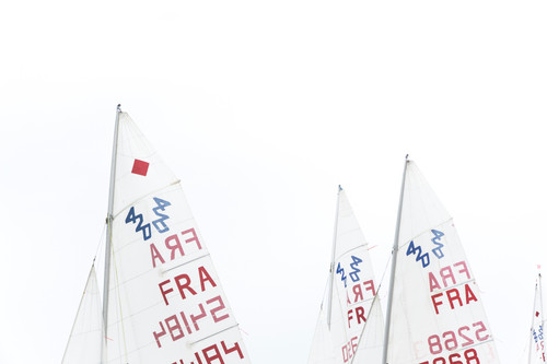 a group of sailboats with red and blue writing.jpg