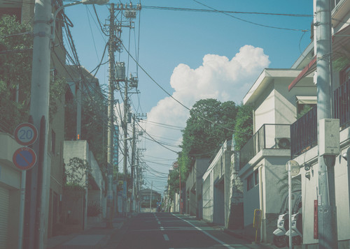 a street with buildings and power lines.jpg