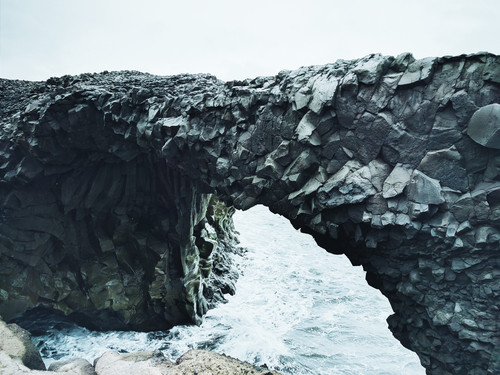 a rock arch over water.jpg
