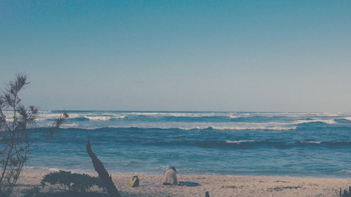 a person sitting on a beach.jpg