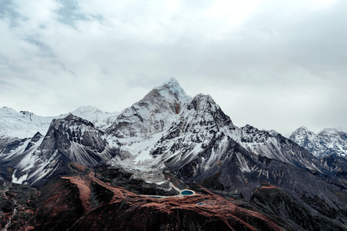 a snowy mountain with a lake in the middle.jpg