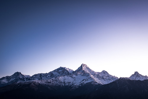 a snowy mountain tops with blue sky.jpg