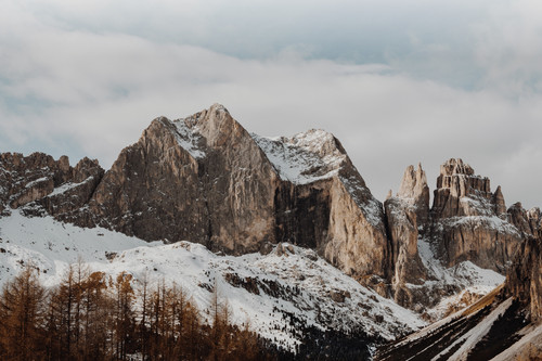 a snowy mountain range with trees.jpg