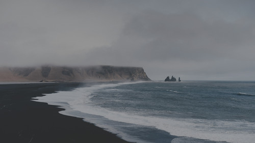 a beach with waves and rocks.jpg