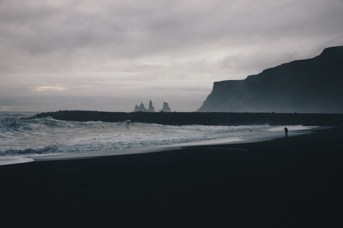 a beach with waves and cliffs.jpg