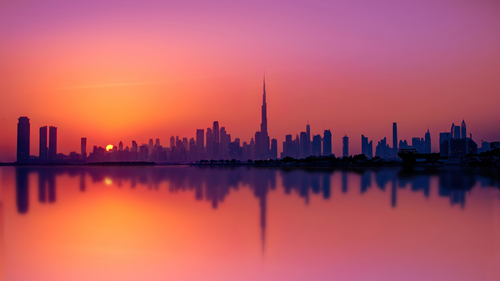 a city skyline with a sunset behind it.png