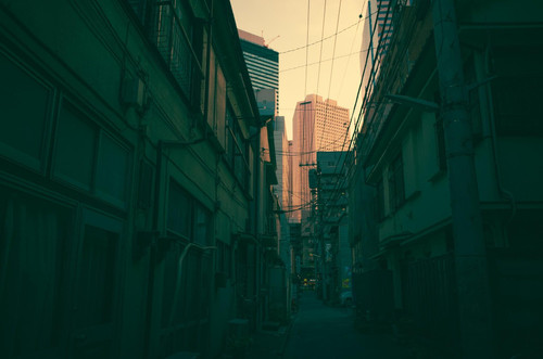 a city alley with buildings and power lines.jpg