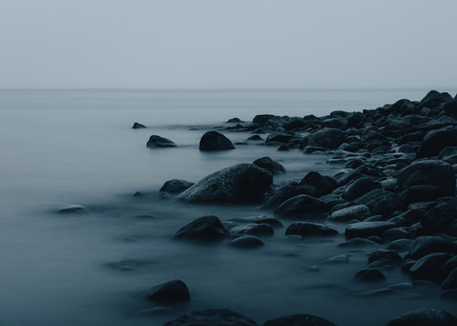 a rocky beach with water in the background.jpg