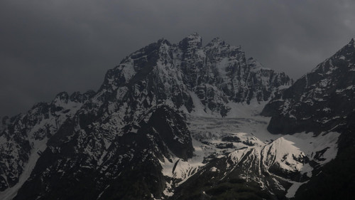 a snowy mountain with dark clouds.jpg
