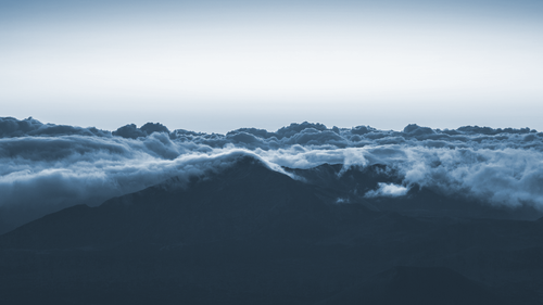 clouds above a mountain.png