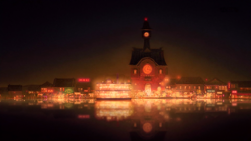 a building with a clock tower and lights on it.png