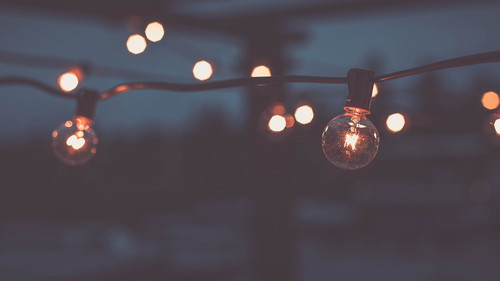 a string of lights with a light bulb.jpg