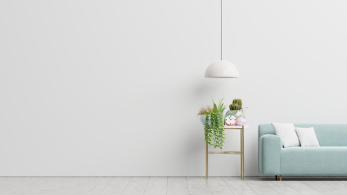 a white wall with a blue couch and a lamp.jpg