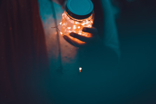 a person holding a jar with lights.jpg