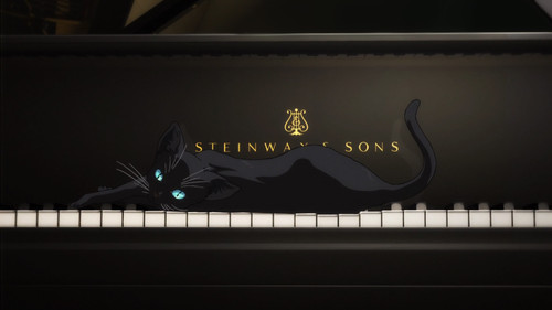 a cat lying on a piano.jpg
