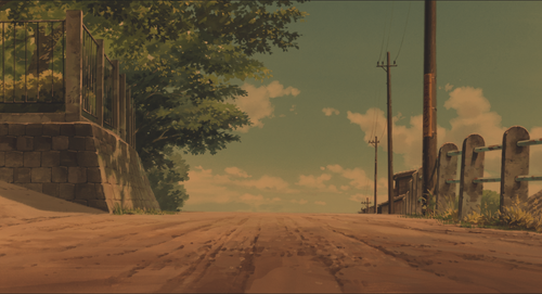 a dirt road with trees and power lines.png
