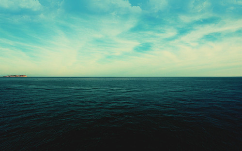 a large body of water with clouds in the sky.jpg