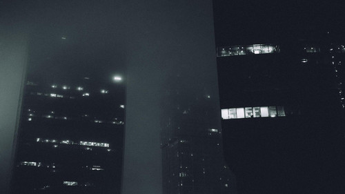 a group of buildings in the fog.jpg