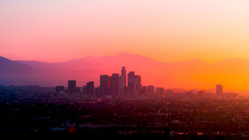 a city skyline with mountains in the background.png