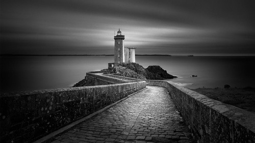 a stone walkway leading to a lighthouse.jpg