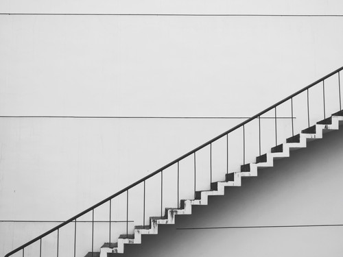 a white staircase with a handrail.jpg