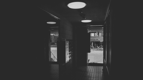 a hallway with lights on the ceiling.png