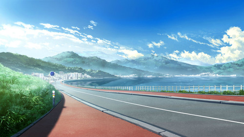 a road with a body of water and mountains in the background.jpg