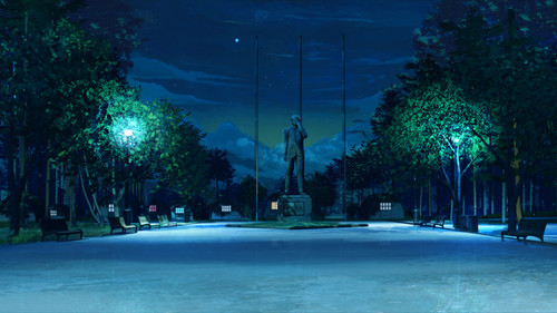 a statue of a man in a park at night.jpg
