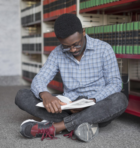 full shot man reading floor.jpg