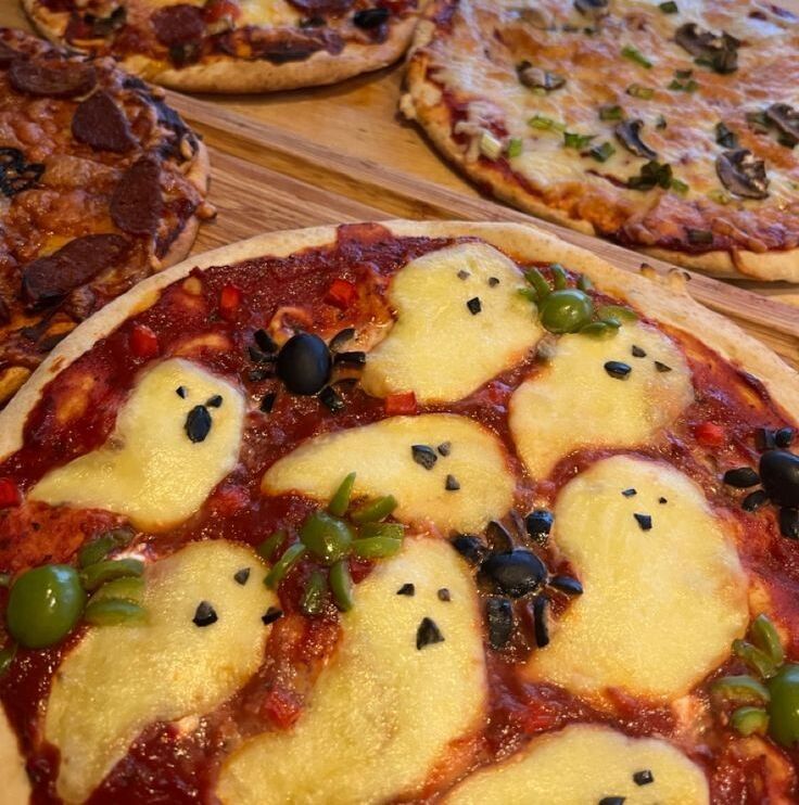 pizzas but the cheese is shaped like a ghost