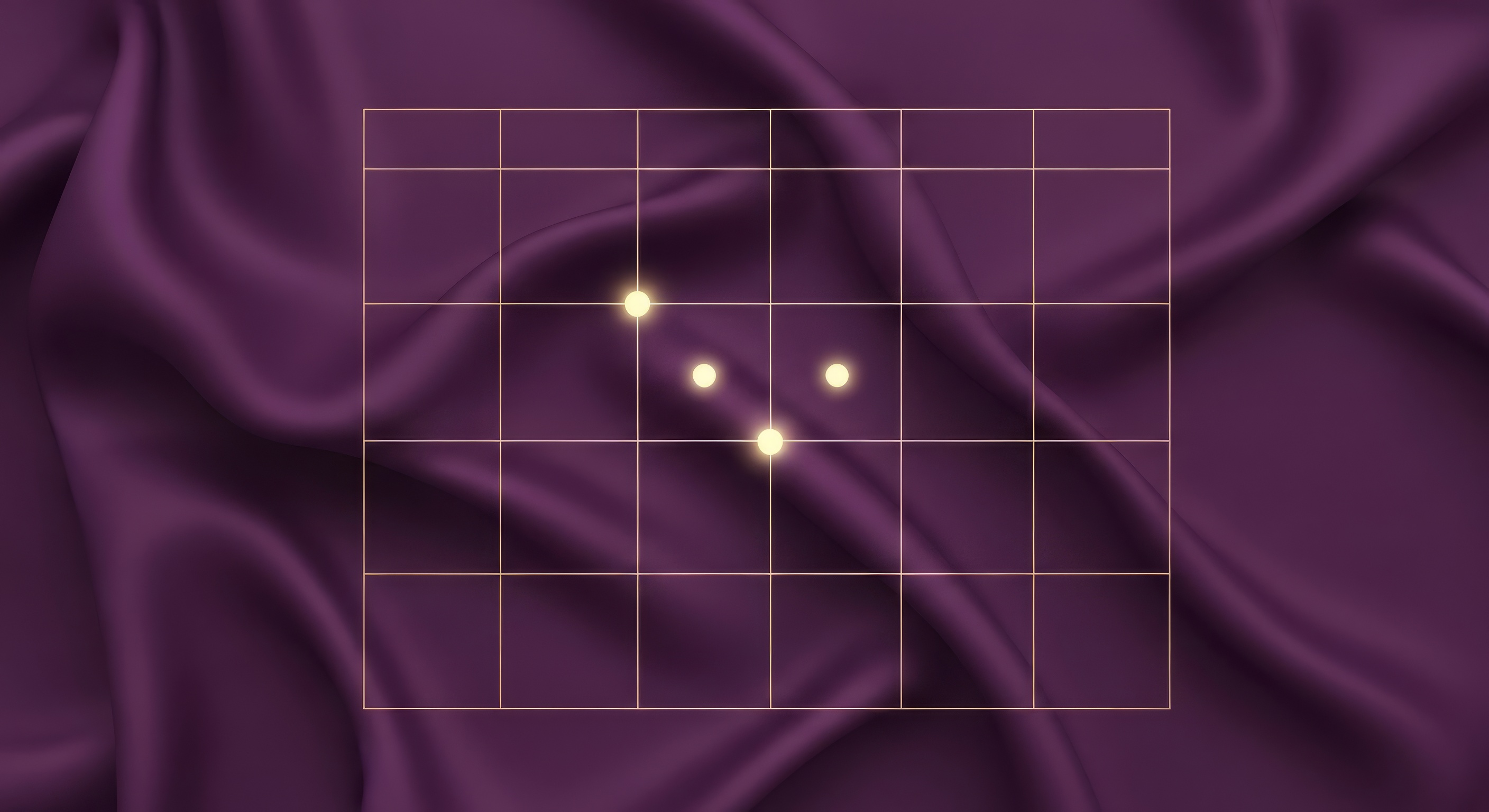 An organized desk with a planner, baby shoes, and a plant